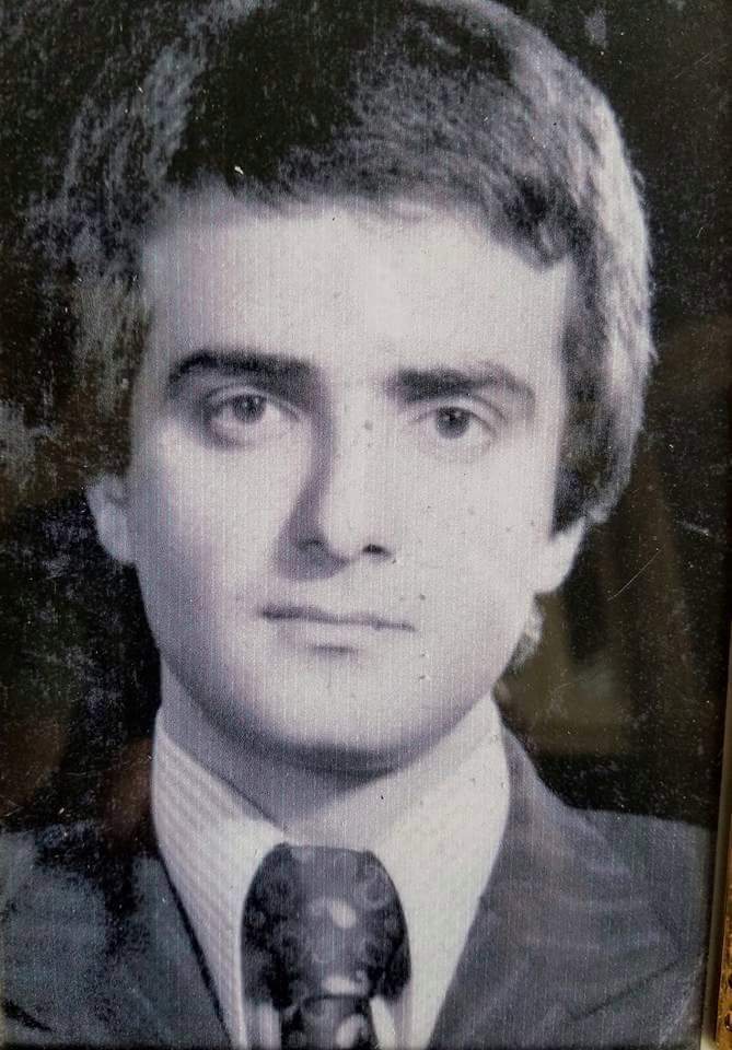 Black-and-white portrait of my dad as a young man in a suit and tie