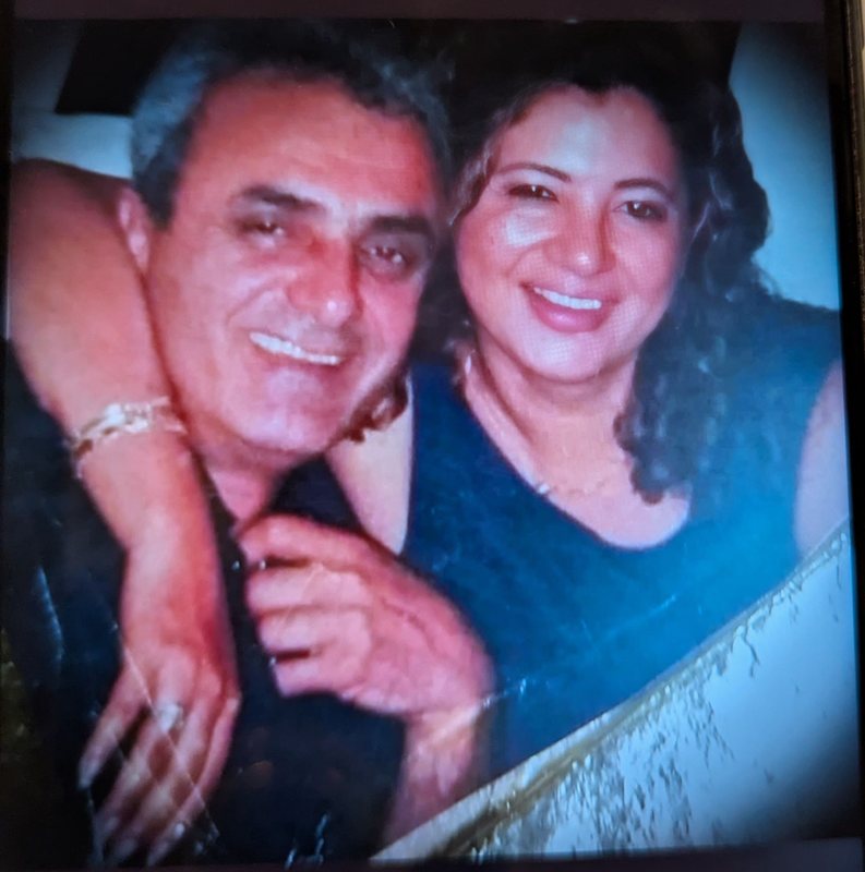 My dad and my stepmom embracing and smiling