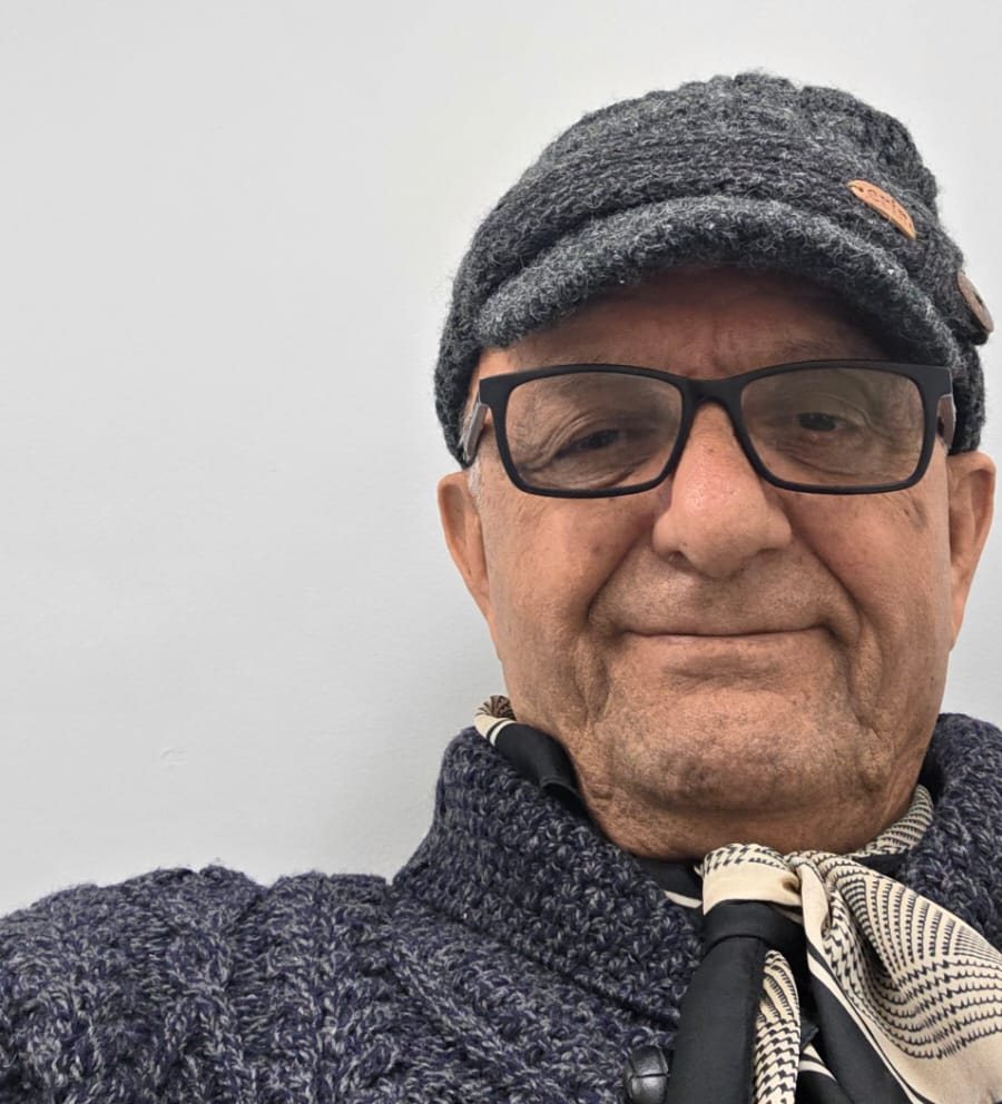My dad in his later years, wearing a knit cap, glasses, and a scarf